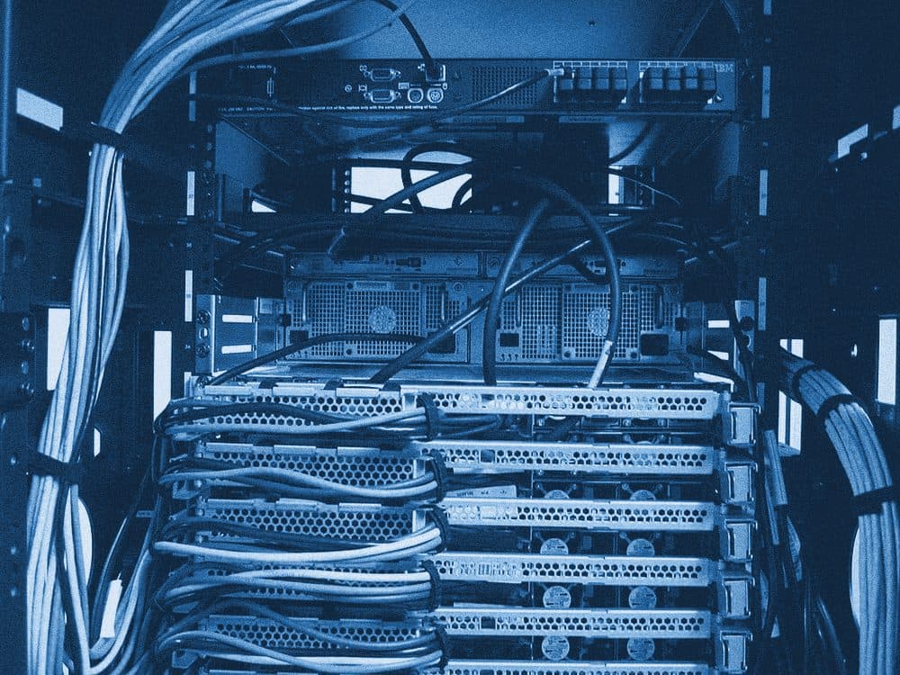 Inside a server rack: servers and bundles of cables