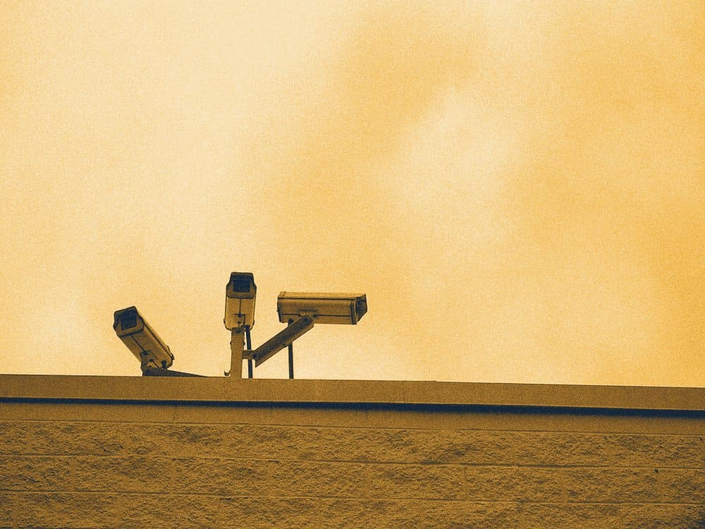 CCTV cameras on a rooftop against the sky